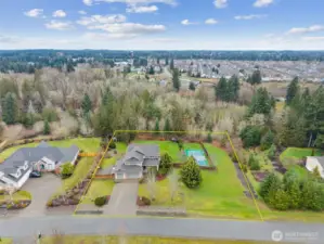 So many options await you on this expansive lot. RV parking on the left through the double gate and sports court to the right.  Plus 5 bedrooms, a media room and bonus room.  Options are endless.