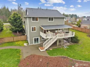 This view really shows how much flexibility the backyard offers. The back of the home opens to a wide, sunny stretch of level ground that’s just waiting for a garden, custom landscaping, or whatever outdoor project you’ve been dreaming up. It feels open, private, and easy to shape over time instead of locked into someone else’s vision. Add in the location, just about twenty minutes to JBLM and close to SE Olympia favorites like shops, restaurants, services, and two nearby golf courses, and suddenly this backyard comes with a pretty great lifestyle attached.