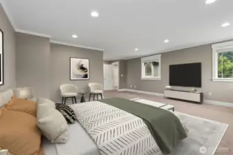 This angle really shows how well the primary suite is laid out. The mounted TV sits perfectly between two windows, giving you light during the day and a cozy setup at night. Across the room, the entry door lines up cleanly with the en suite bath and walk in closet, keeping everything intuitive and easy to move through.