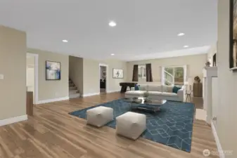 Big, bright, and fully finished, this downstairs daylight recreation room features medium tone wood floors that warm the space right up, soft muslin walls, and a crisp white ceiling that keeps everything feeling light. The gas fireplace with a classic white mantle adds a cozy focal point without stealing the show, and the large window and sliding glass door brings in plenty of natural light. Media room, recreation space, or home pub gathering zone, this room is ready to flex!