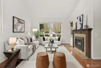 Living room with gas fireplace and beautiful hardwood flooring!