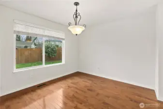 Hardwood floors carry through the dining room, adding warmth and elegance for every gathering.