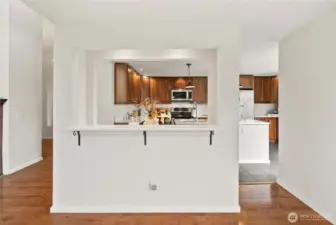 Another view of the pass-through bar area into the beautiful kitchen, complete with a convenient wine fridge just beyond the wall.