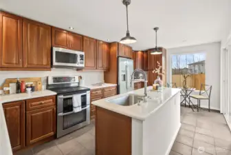 Stainless steel appliances complement smart storage throughout.