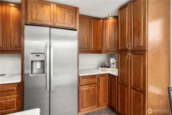Convenient refrigerator and coffee bar setup keeps everything within reach.