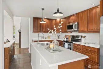 Eye catching pendant lighting, modern faucet, and a functional island make this kitchen both beautiful and practical.
