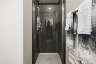 Eye-catching tile shower adds a touch of luxury.