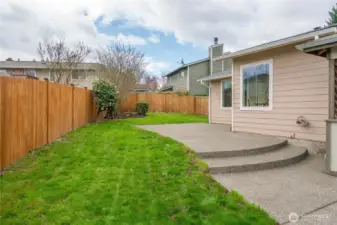 Fenced backyard makes outdoor living simple and enjoyable.