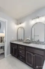 Double vanity complete with custom lighting and mirrors.