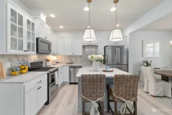 Modern white cabinetry, stainless steel appliances and trendy light fixtures steal the show.