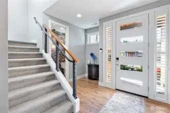 Light & open entry with contemporary paint colors and high ceilings. Power room is off to the right. Gorgeous flooring too.