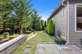 Back yard is well manicured with lush landscaping.