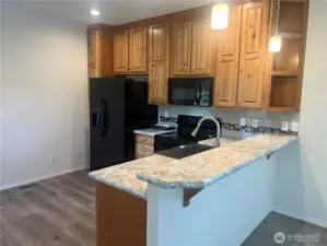 Another view of the kitchen with eating bar.