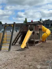 A large play structure~often referred to as a "Big Toy"~features slides, climbing elements, ladders and platforms.  It's designed for a range of ages.