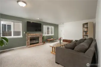 Lots of natural light shimmers as you enter the townhome.  The brick fireplace and hearth are a lovely accent to the space.