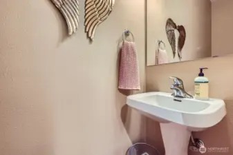 Main floor powder room w/pedestal sink. Total of 4 bathrooms in the home!