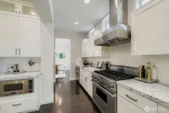 Chef's Kitchen With Dual Prep Areas, Slab Counters & Stainless Steel Appliances