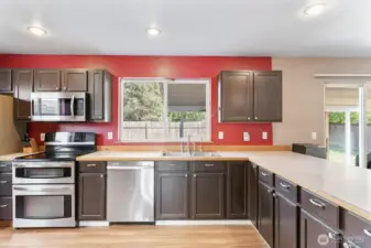 View of large kitchen space from pantry - stainless steel appliances stay