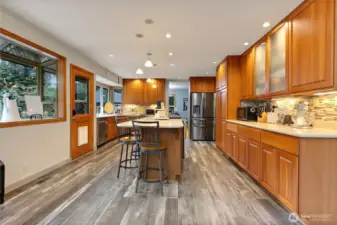 Kitchen with a door to the back patio. Lots of cabinet storage and large oversize island.