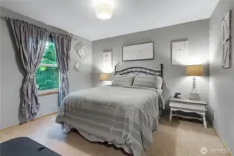 Main floor 2nd Bedroom with window facing back of the home.