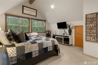 Primary bedroom with the windows facing the back of house.