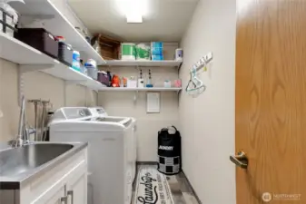Utility Room with built in shelving, utility sink.