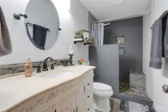 Basement 3/4 bathroom. Shower has multiple shower heads and wand.