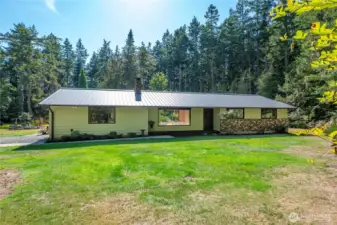 Beautifully situated on nearly 5 acres, this charming home has it all! Drenched in sunshine yet surrounded by majestic trees of many species, and beautifully landscaped surround.