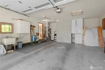Large two car garage, with cabinets, work bench and new garage door. See virtual tour link for 3D walkthrough video, interactive floor plans and more. Updated propane furnace and water heater, along with whole house vacuum system
