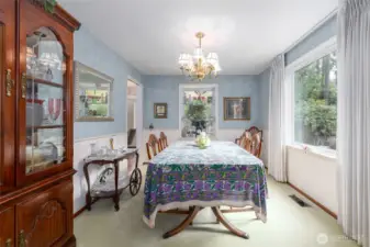 A large formal dining area with picture window to frame the garden view.