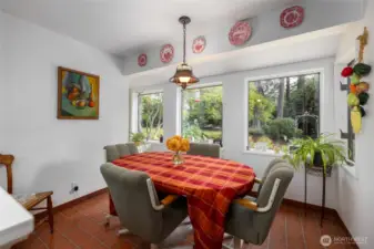 This charming and light-filled breakfast area in the kitchen looks out to the deck and back yard.