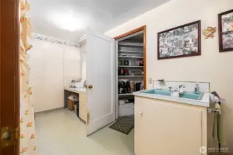 This huge utility/sewing room has tons of storage, a deep sink, and room for crafts or a home office.