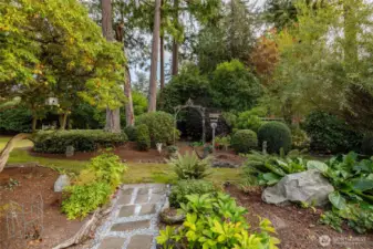 This well-designed yard offers multiple areas for gathering, gardening, or just enjoying the outside.