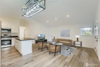 Virtually staged. Enter your new home with all fresh clean walls and surfaces to customize to your desire. Luxury Vinyl Plank (LVP) flooring throughout this home makes it a seamless transition to each room. Convenient canned lights, modern candelier and vaulted ceilings make this space feel larger! Far door leads to the garage and backyard.