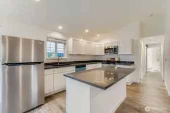 Island has storage on one side and an eating counter on the other.