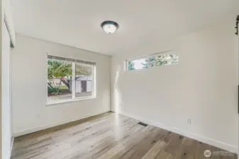 Primary bedroom with window facing the backyard.