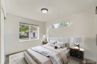 Virtually staged. Primary bedroom with window facing the backyard.