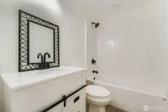 Main hallway bathroom. Everything left pristine for your decorating eye to finish the details. Sellers can install the mirror or you can choose and hang one of your choosing!