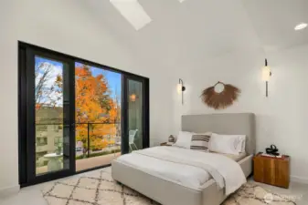 Primary Suite with Vaulted Ceilings and Skylights. Doors to Private Balcony.