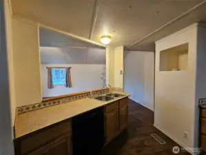 Work in the kitchen while engaging with living room.