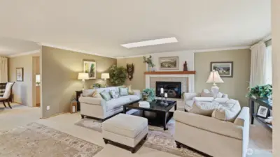 Spacious living area anchored by a charming fireplace and abundant natural light.