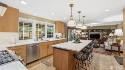 Chef’s kitchen featuring custom cabinetry, upgraded lighting, and generous prep space.