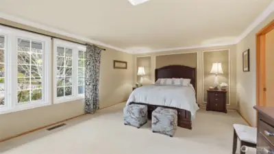 Serene bedroom retreat with elegant trim details and oversized windows.