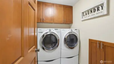 Functional laundry room with cabinetry for organized living.