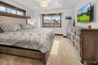 Primary bedroom with King Bed, ceiling fan, walk in closet and ensuite bath. Large TV