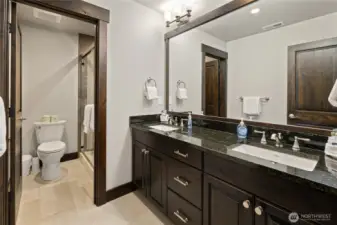 4th bedroom bathroom with tile floors, granite counters double sinks