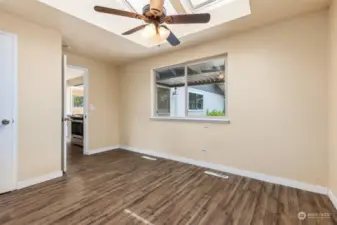 Located right off of the family room and kitchen, your first bedroom option! With a huge skylight filling this space with light and fan, it also has a ¾ bathroom attached for use as a primary suite.