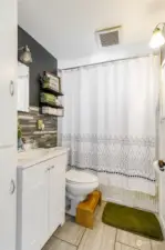 This full bathroom with tile flooring is centrally located near the three bedrooms and has a unique fan feature! (See Seller Disclosure for operating details.)