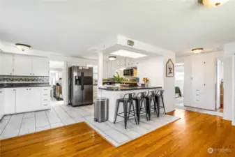 Hardwood and tile separate the living/dining room from the kitchen area, and you have a ton of storage on the left plus all that counter space! Three bedrooms are to the right with built-in drawers and shelving in the hallway.