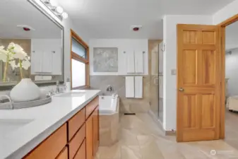 Primary bathroom off bedroom. Quartz slab and tiles for easy maintenance.